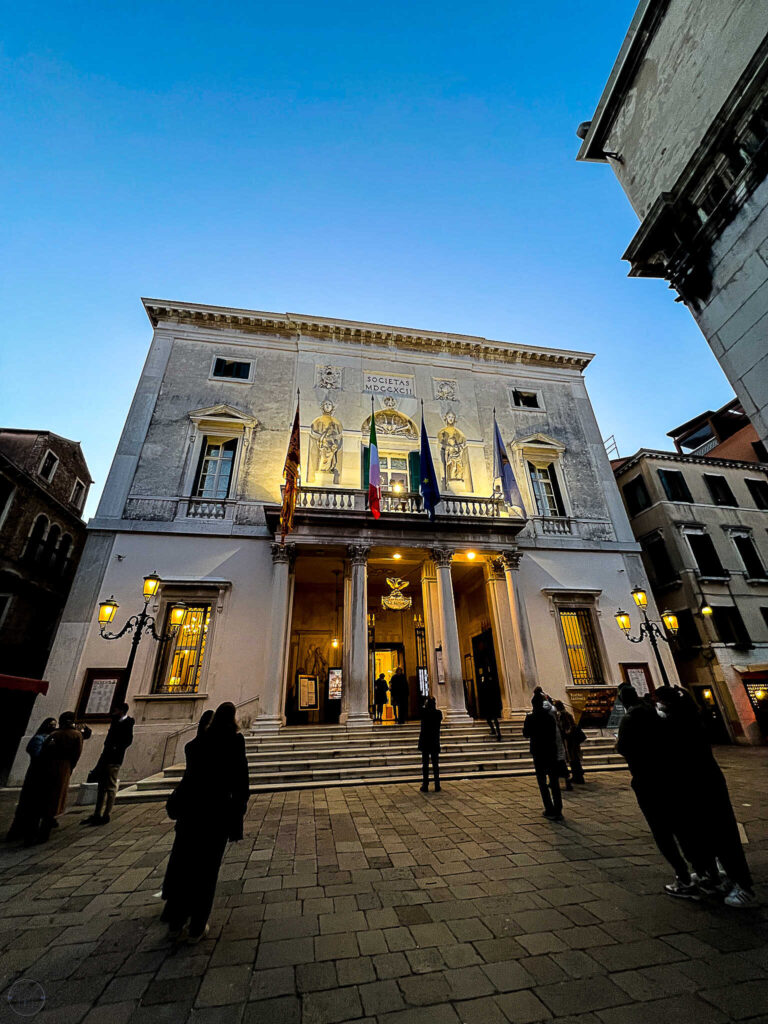 This is an image of the outside of Teatro La Fenice in Venice Italy at night.