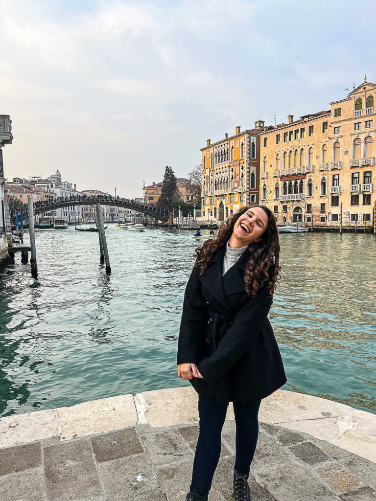 This is an image of Lyndsay the creator of the Purposely Lost standing in front of the Ponte dell'Accademia in Venice Italy.