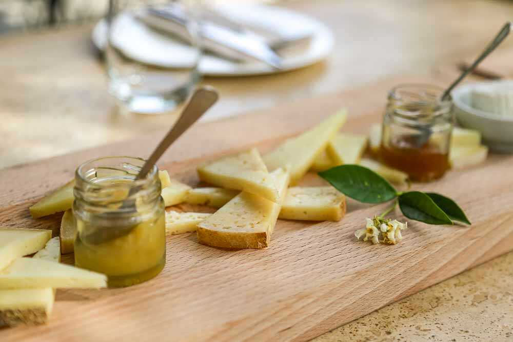 This is an image of cheese and small pots of honey at Podere il Casale in Pienza, Italy.