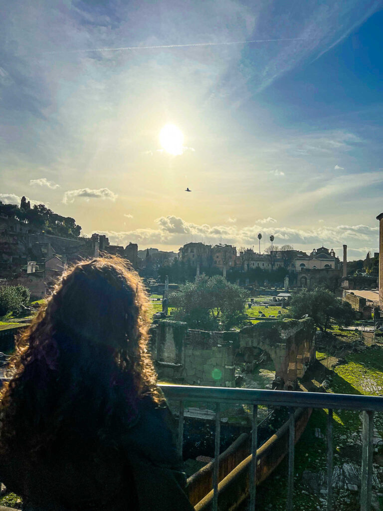 This is an image of a woman looking out at the Roman Forum in Rome, Italy