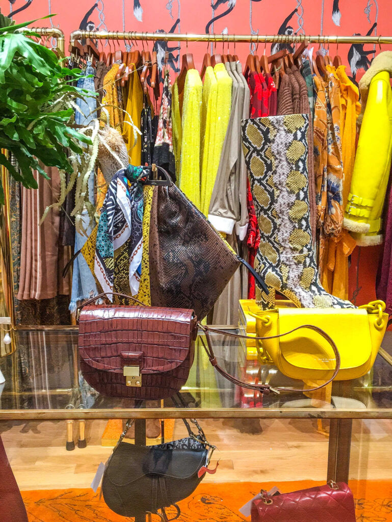 This is an image of purses and clothes hanging up in a pop-up shop in New York City.