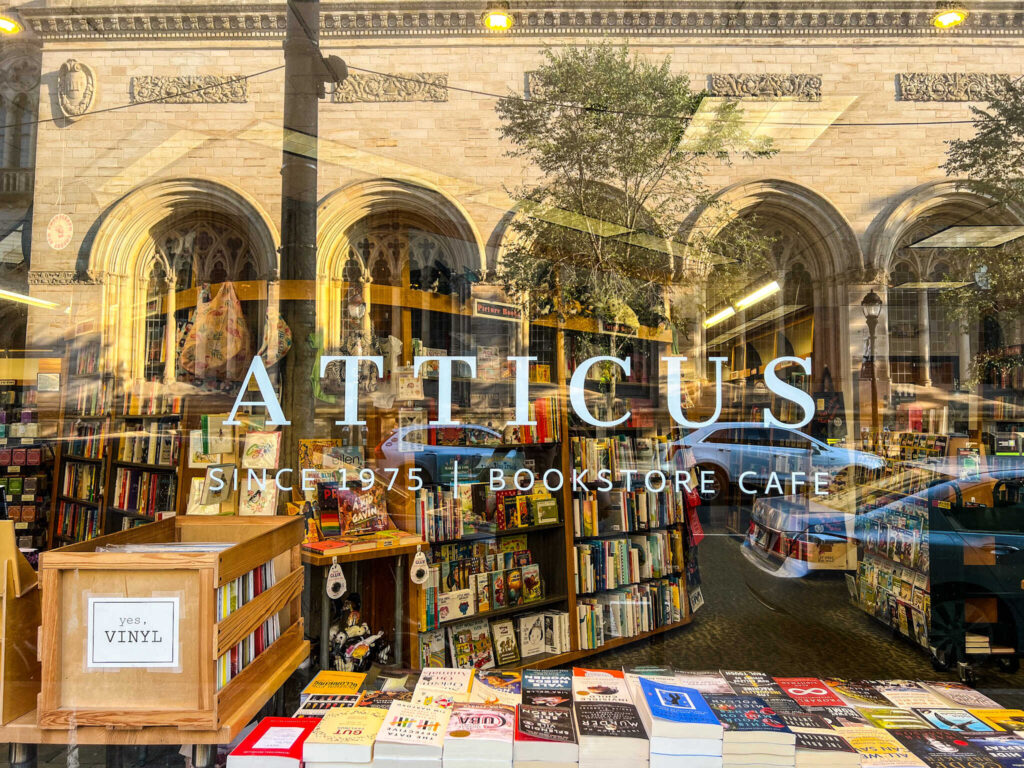 This is an image of the entrance sign on the window of the Atticus bookstore café in New Haven Connecticut.