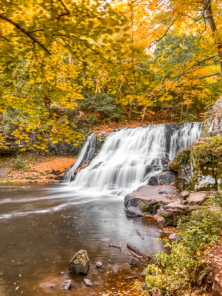 This is an image of a waterfall in the fall in Connecticut.