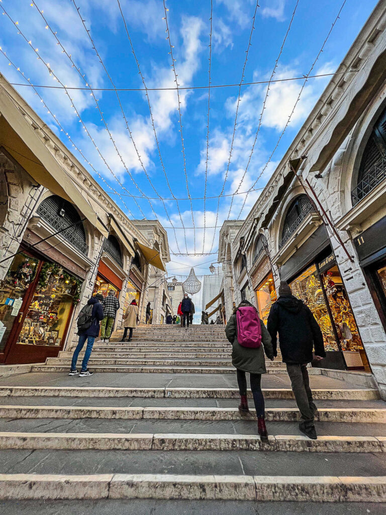 This is an image of the view walking up the Rialto Bridge in Venice, Italy.