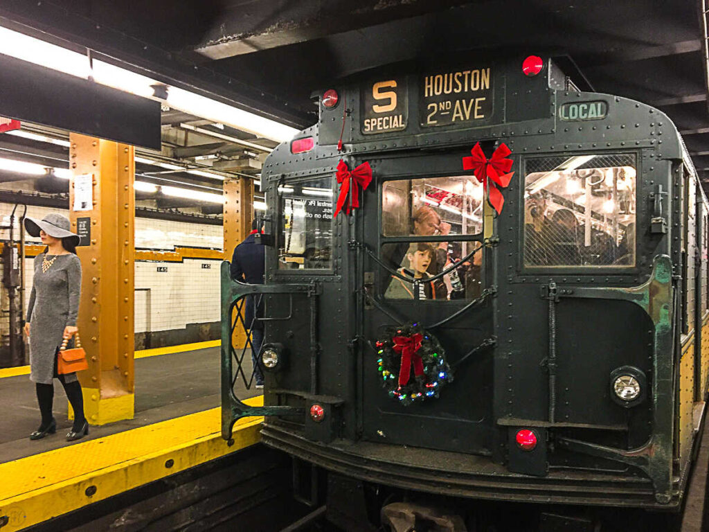 This is an image of the holiday train decorated for the Christmas season. It's a vintage New York City subway, train car in NYC.