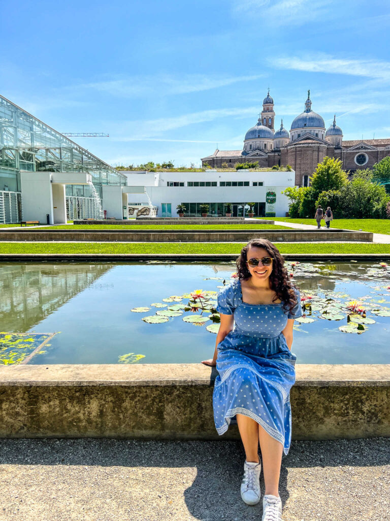 This is an image of Lyndsay, the creator of The Purposely Lost, sitting in the botanical garden in Padua, Italy.