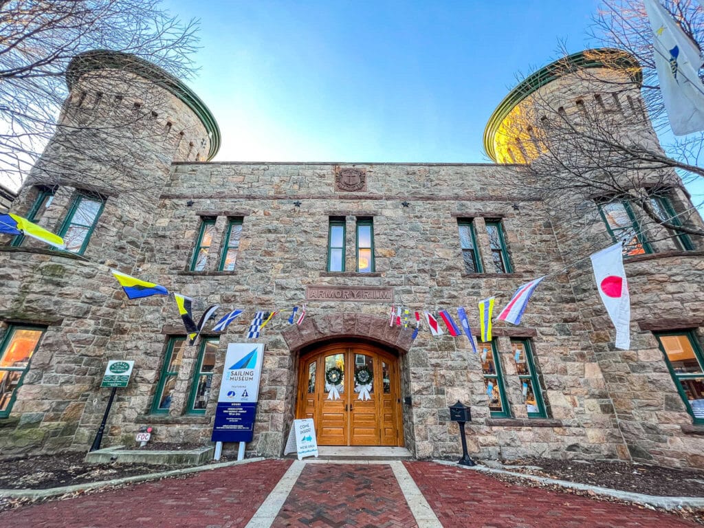 A stone building with flags and flagpoles, located in Newport.